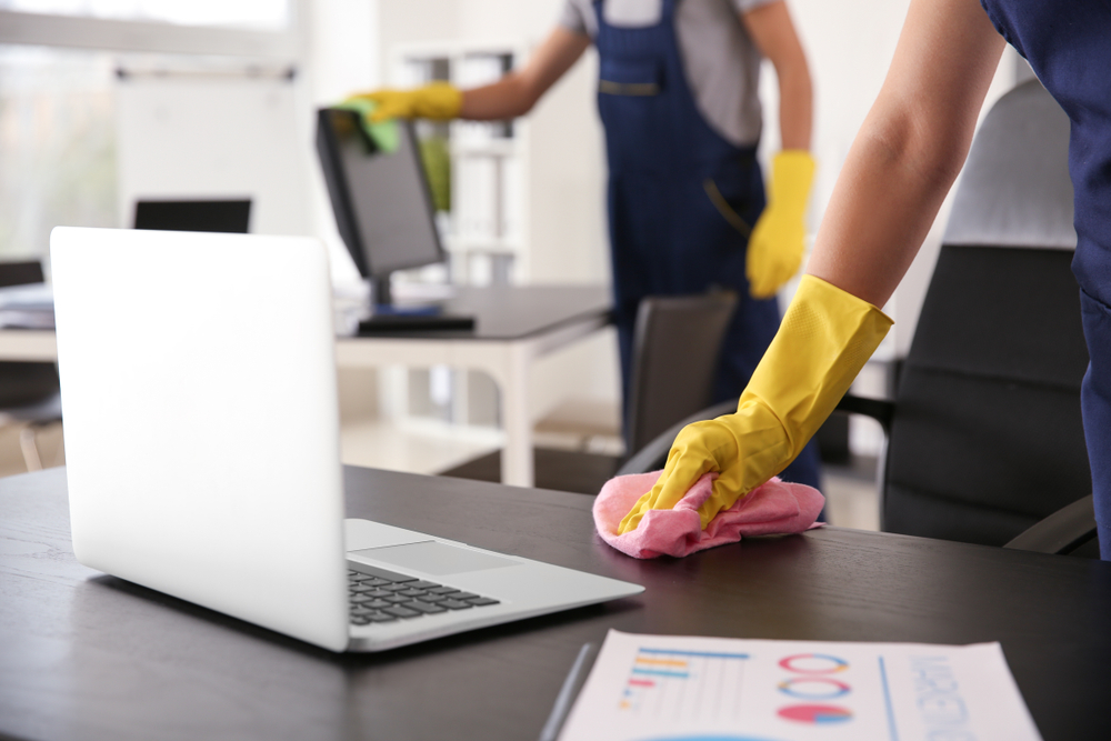 Janitor,Wiping,Table,In,Office